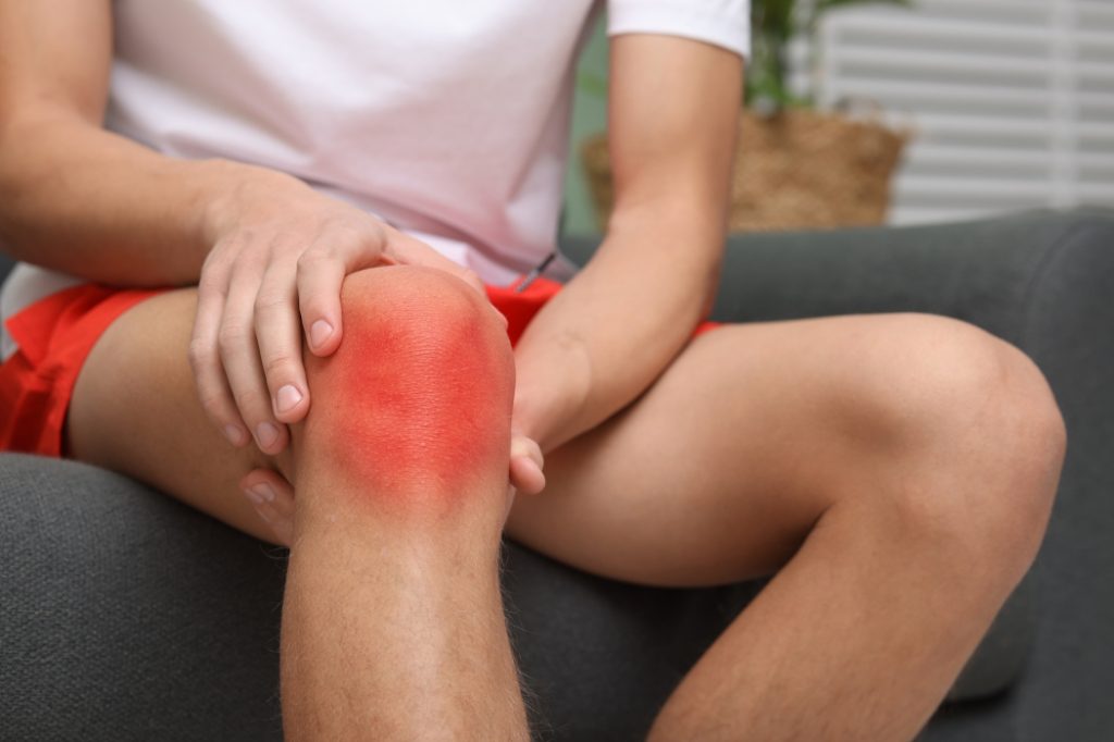 A young runner is suffering from knee pain.